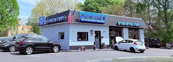 Wide panoramic view of the LRS Auto Service shop exterior, open service bays, and parking area