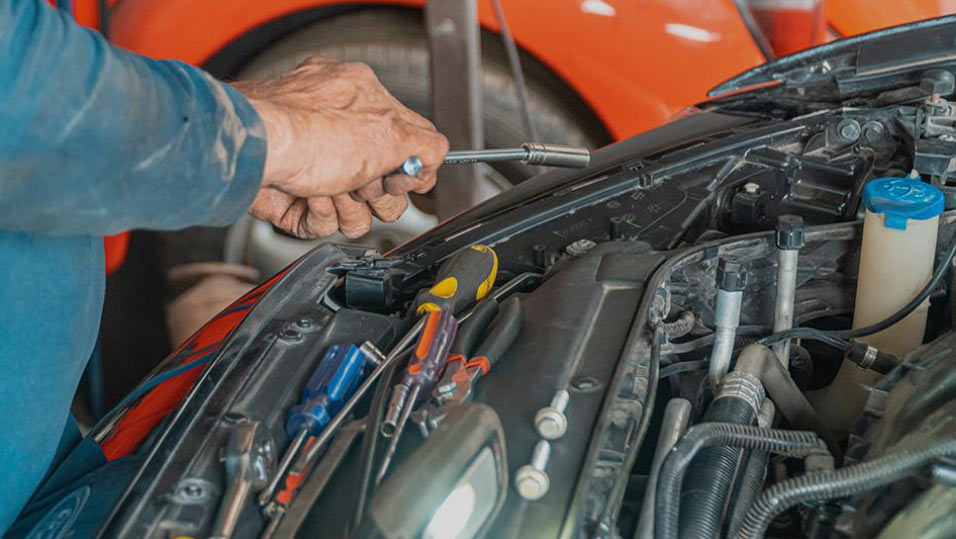 LRS Auto Service technician performing under-hood diagnostics and repair work